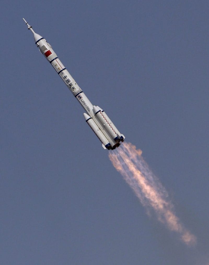 A Long March 2F during first-stage flight carrying a Shenzhou spacecraft.